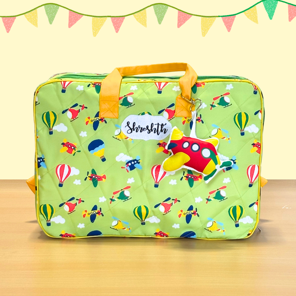 Green suitcase with airplane pattern