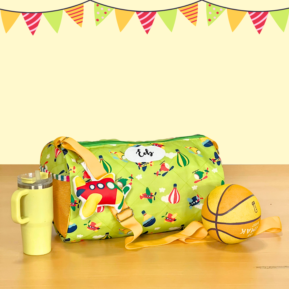 Green travel bag with colorful designs