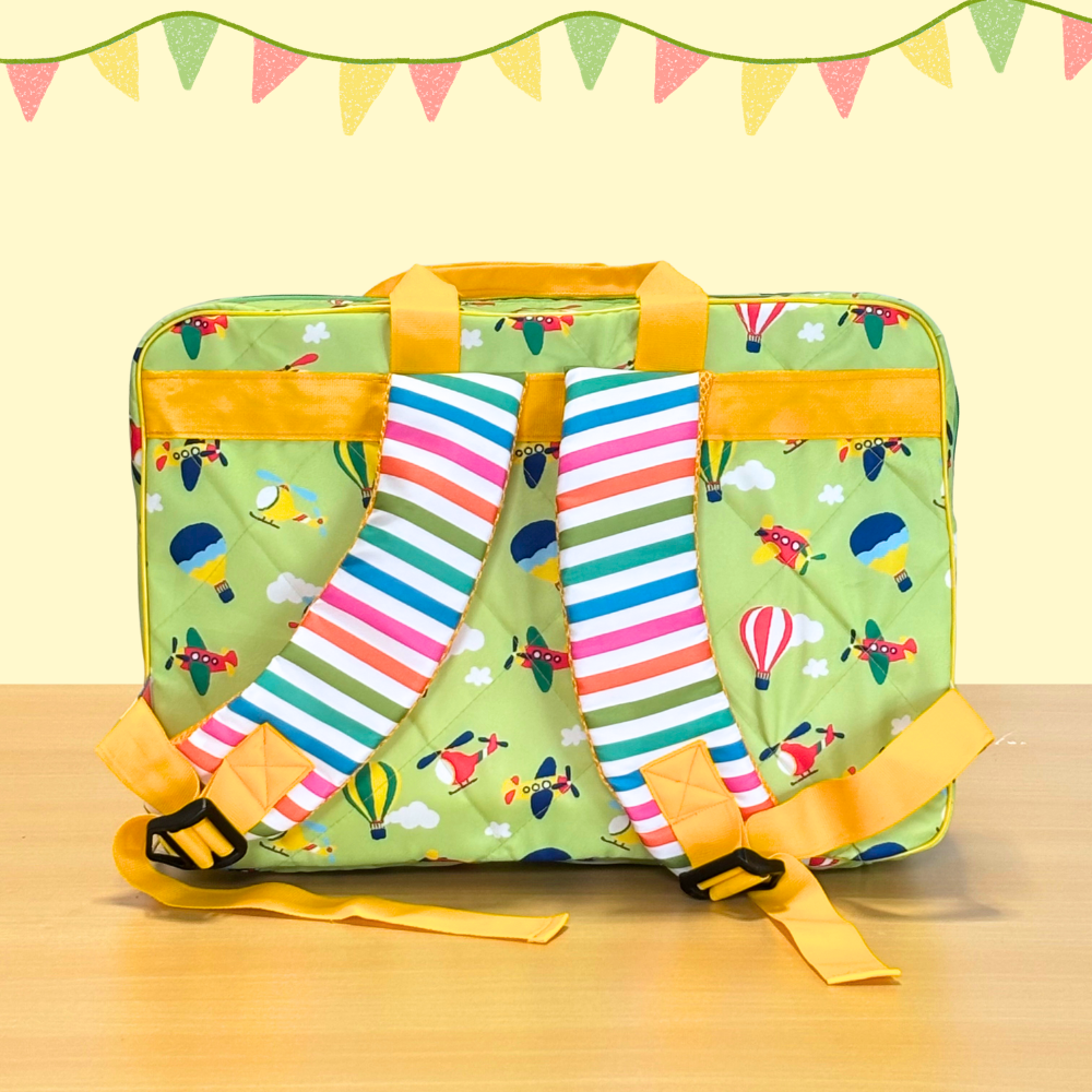 Green suitcase with colorful airplane pattern